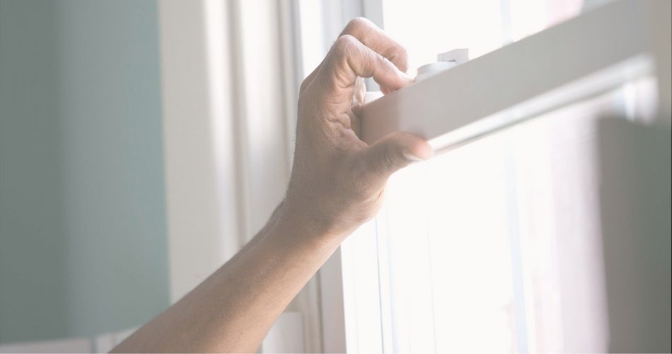 hand touching rental cabin window